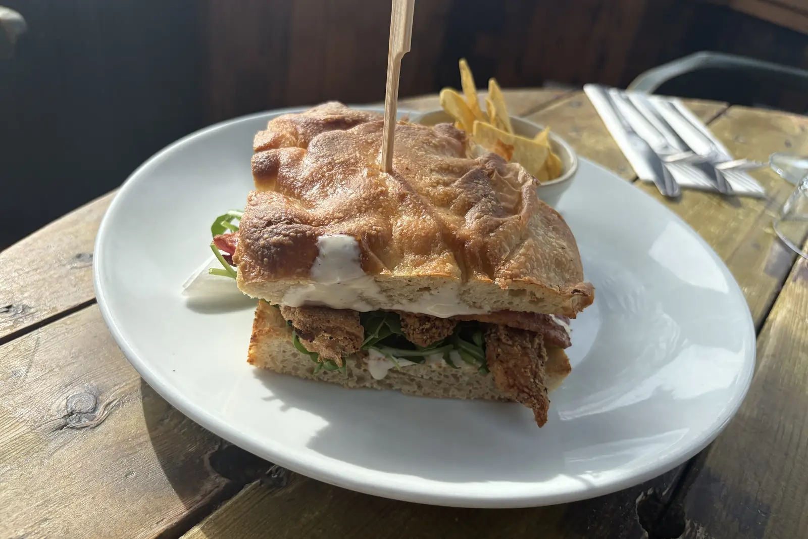 A toasted ciabatta sandwich with tortilla chips by a sea-view window at The Ship Inn, Sandgate