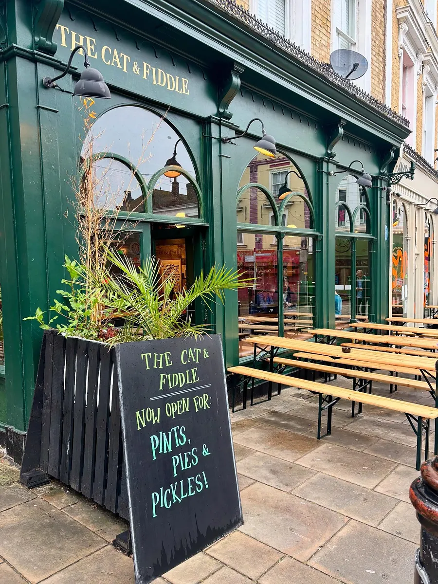 Cat & Fiddle’s green shopfront on Rendezvous Street, with its gold name lettering and arched windows